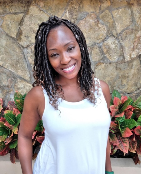 Sandra, Tax Strategist and IRS Enrolled Agent, smiling outdoors with a scenic background, representing her expertise and digital nomad lifestyle.